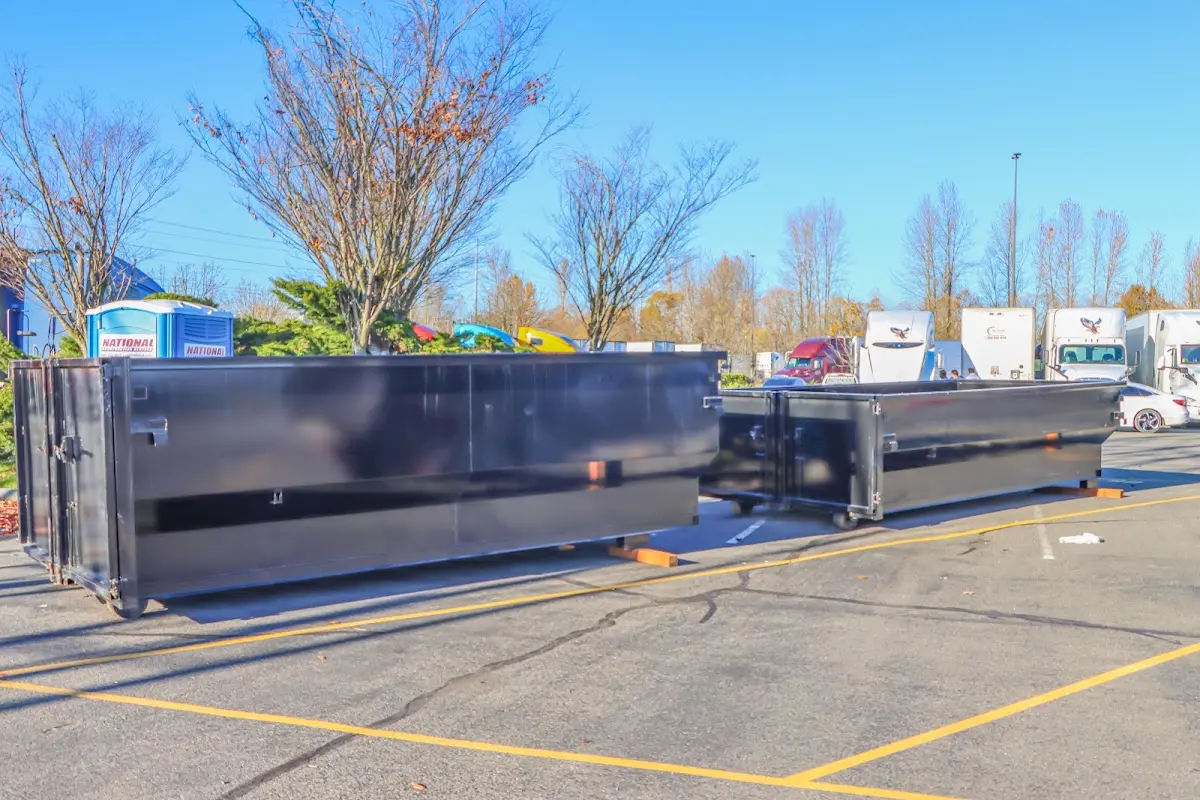 Professional dumpster rental service with roll-off container on residential driveway in Carson